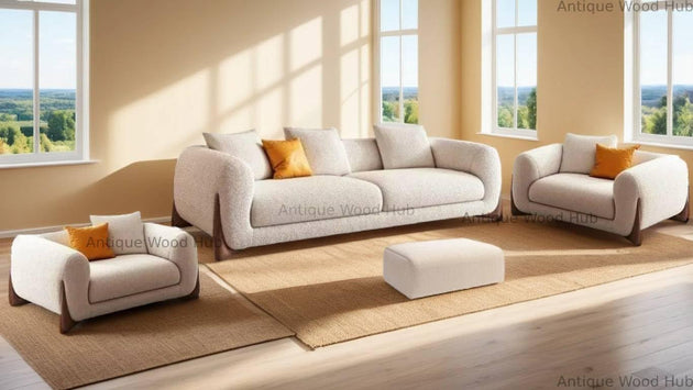 White sofa set with orange cushions in a bright living room.