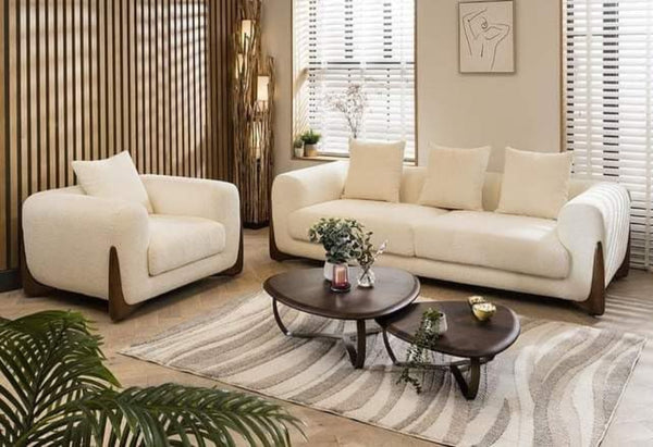 Modern living room with white sofa set and wooden coffee table.