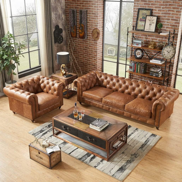 Brown leather sofa and armchair in a living room with wooden coffee table and decorative items.