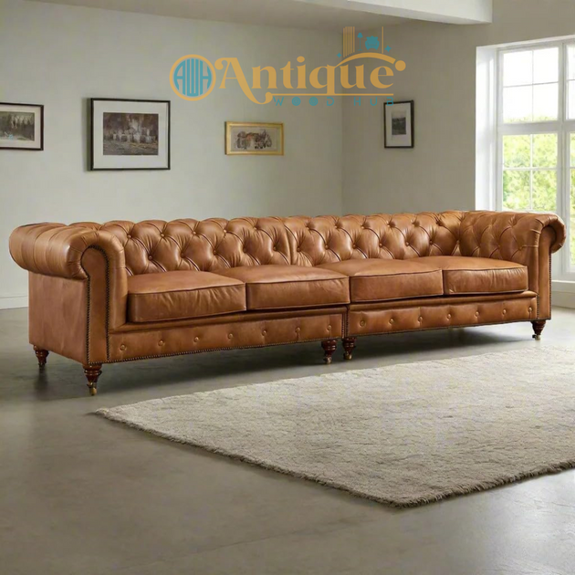 Brown leather sofa in a room with framed pictures on the wall and a window.