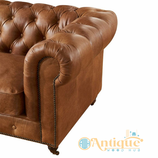 Brown leather sofa with tufted backrest on a white background, featuring 'Antique Wood Hub' logo.