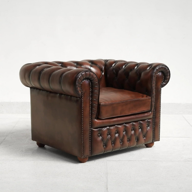 Brown leather armchair with tufted backrest on a white background