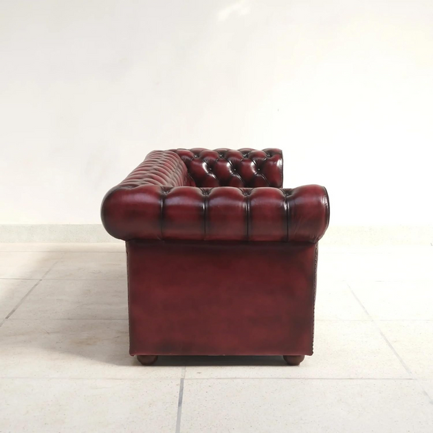 Red leather Chesterfield sofa on a white background