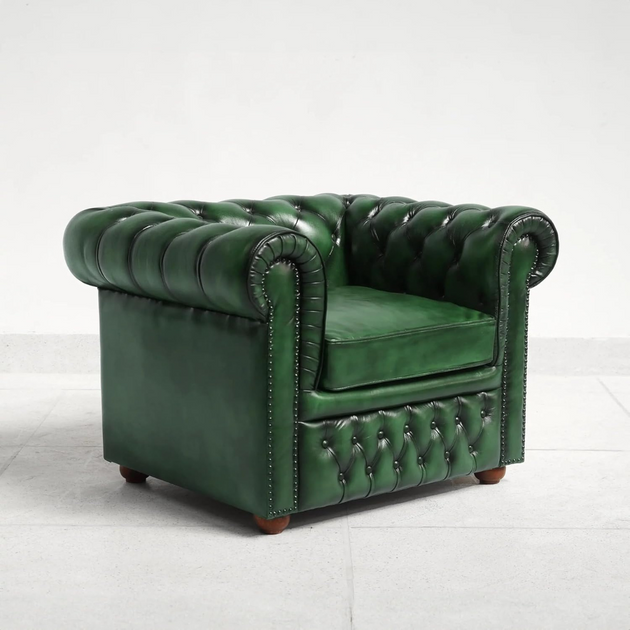 Green leather armchair on a white background