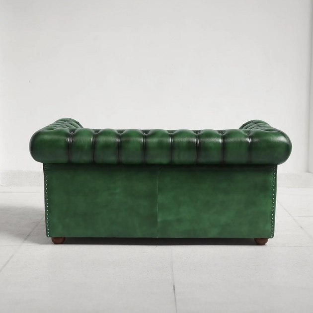 Green leather sofa on a white background