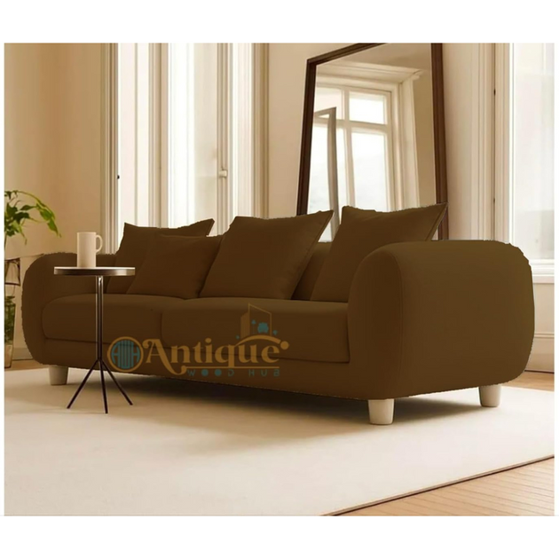 Brown sofa in a living room with a side table and mirror.