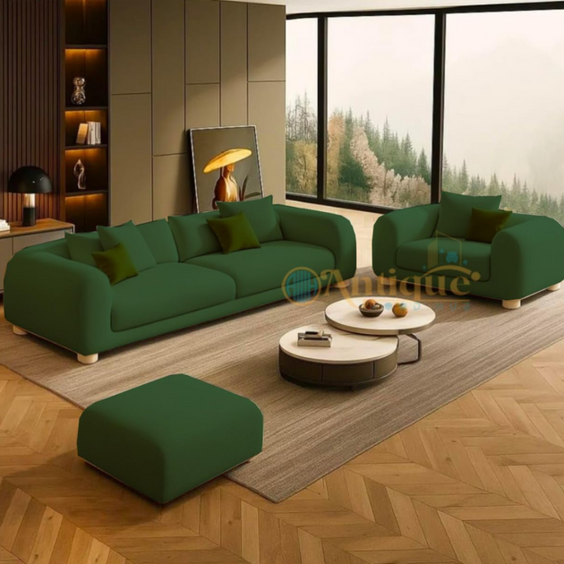 Green sofa set in a modern living room with wooden floor and large windows.