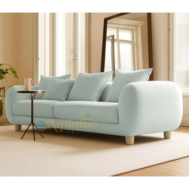 Light blue sofa with cushions in a living room setting