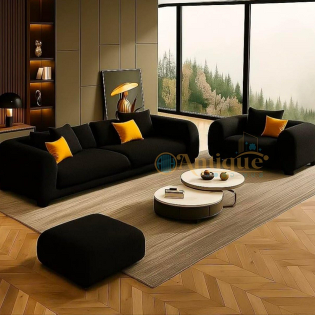 Modern living room with black sofas, yellow cushions, and a coffee table.