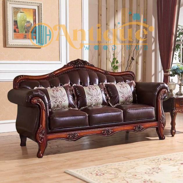 Brown leather sofa with floral cushions in a room with wooden flooring and decorative elements.