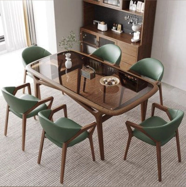 Dining room with a glass table and green chairs in a modern interior setting.