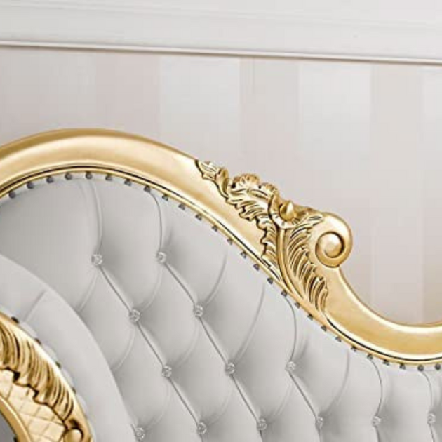Decorative headboard with gold accents and tufted white design.